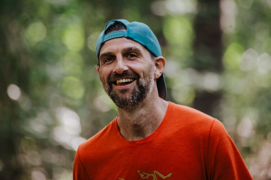 Smiling male runner in a cap, one of the entrants for the 2024 Anchor Down Ultra Marathon.